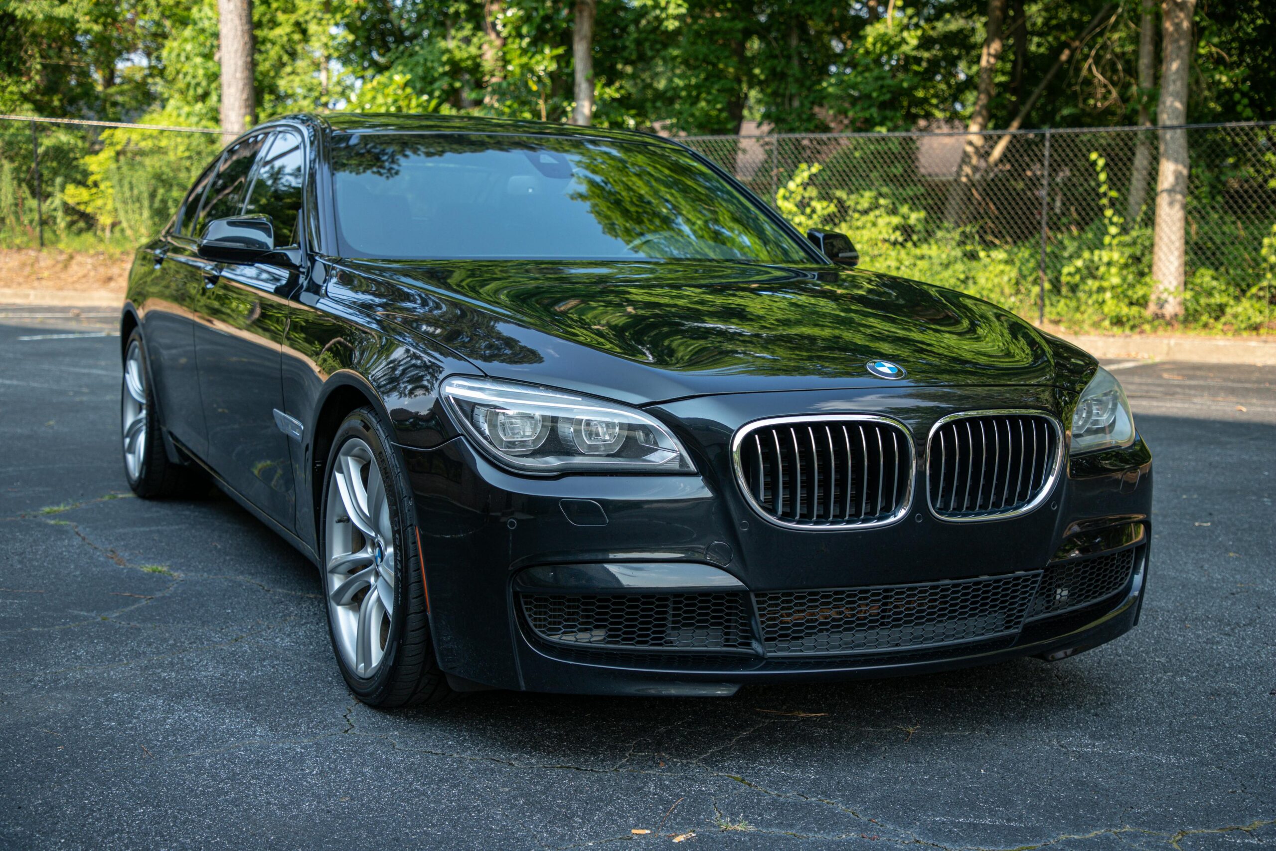 Vehicles Close-up of a parked black luxury BMW car with shiny exterior.